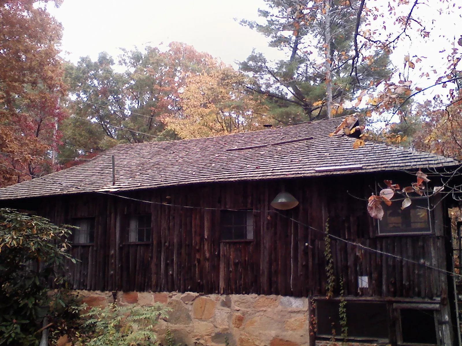 Weathered wood shake roof on a rustic board sided cabin in Pardeeville