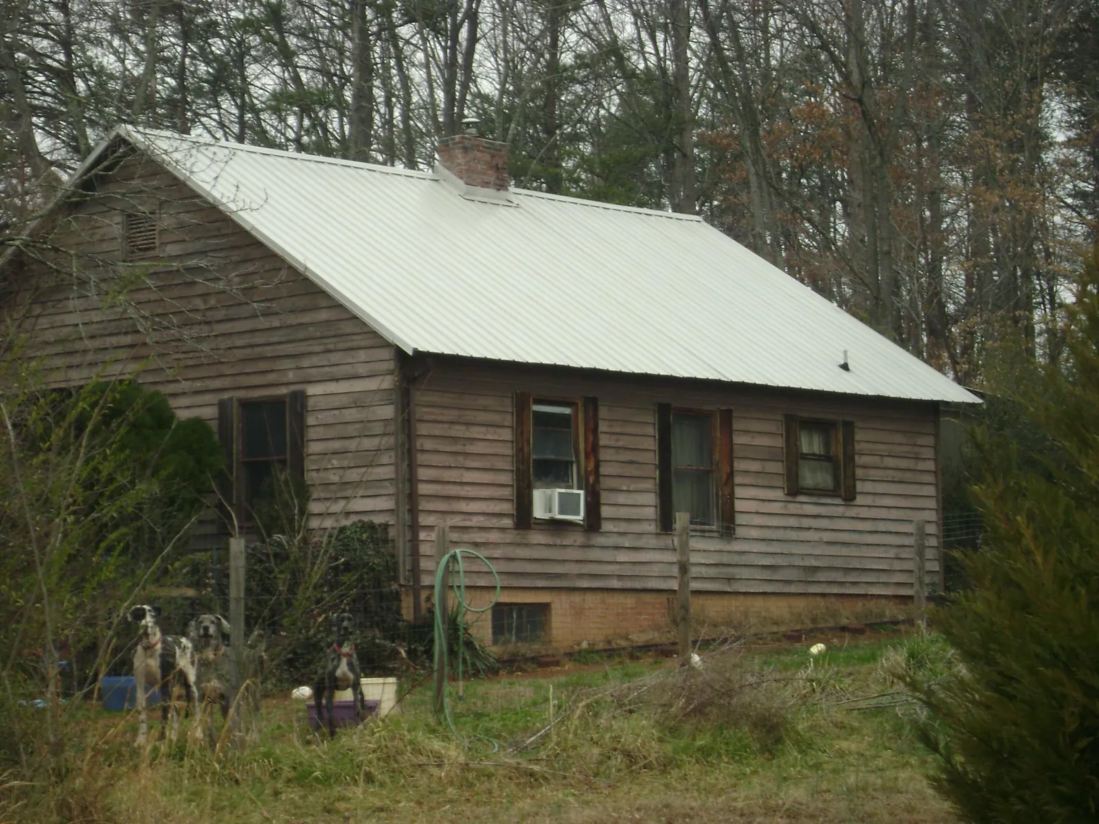 White metal roof on an old wood sided farmhouse, from a Metal Roof Installation job in Pardeeville